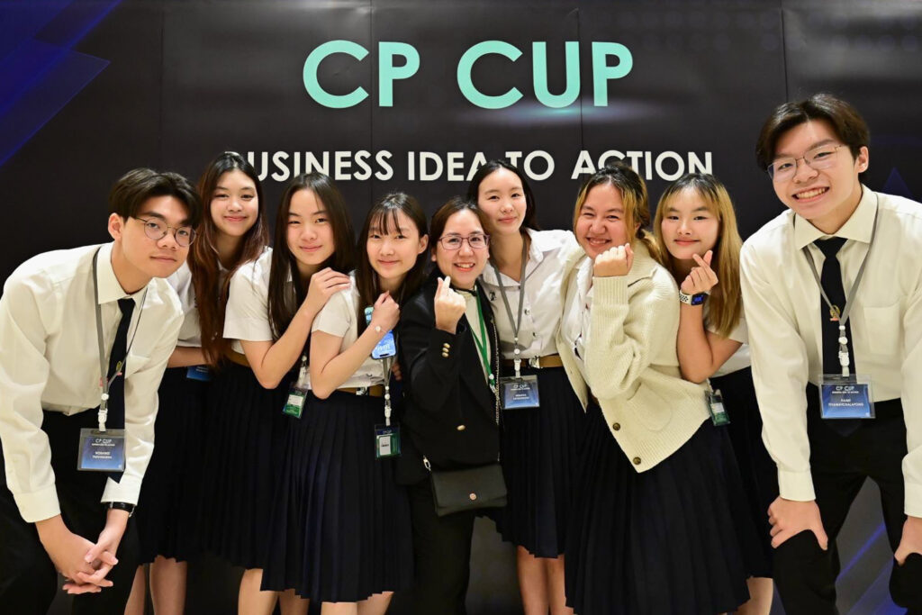 A group photo of BAScii Year 1 students from Team "Chill Guy" celebrating their success at the CP Cup competition, posing with their mentor, Dr. Warinya Chemnasiri. The team secured 2nd place in the Thailand round and won the Grand Prize in the international final, showcasing their innovation and entrepreneurial spirit.