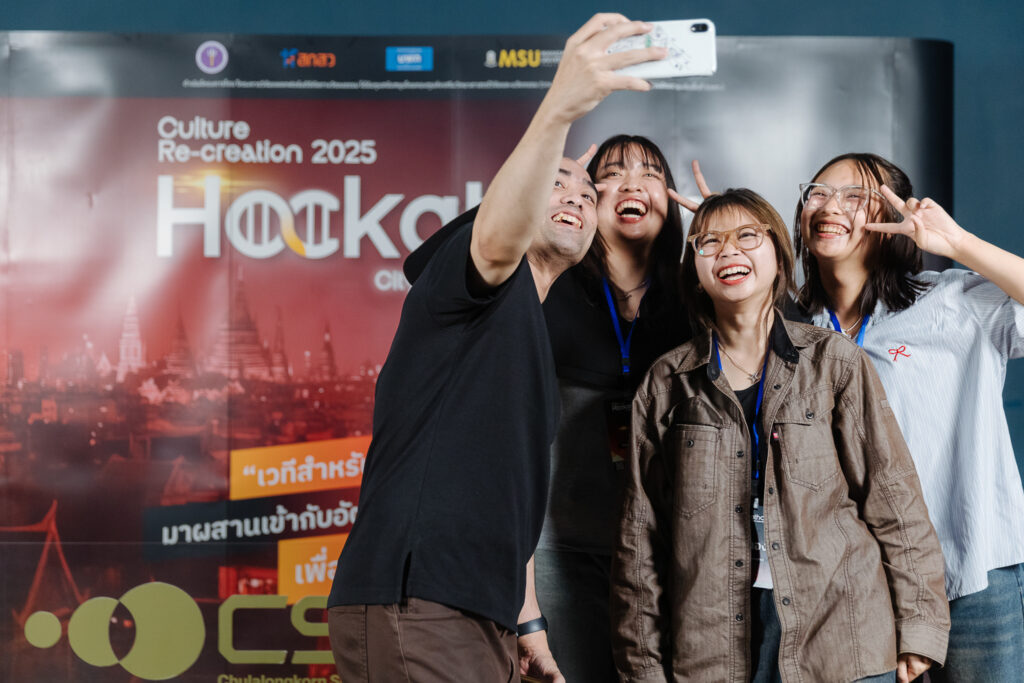 A group of enthusiastic participants at the City DNA & Culture Re-creation Hackathon 2025 take a celebratory selfie, capturing the energy and excitement of the event. The hackathon, organized by CSII and Mahasarakham University, fosters innovation in cultural preservation and commercialization.